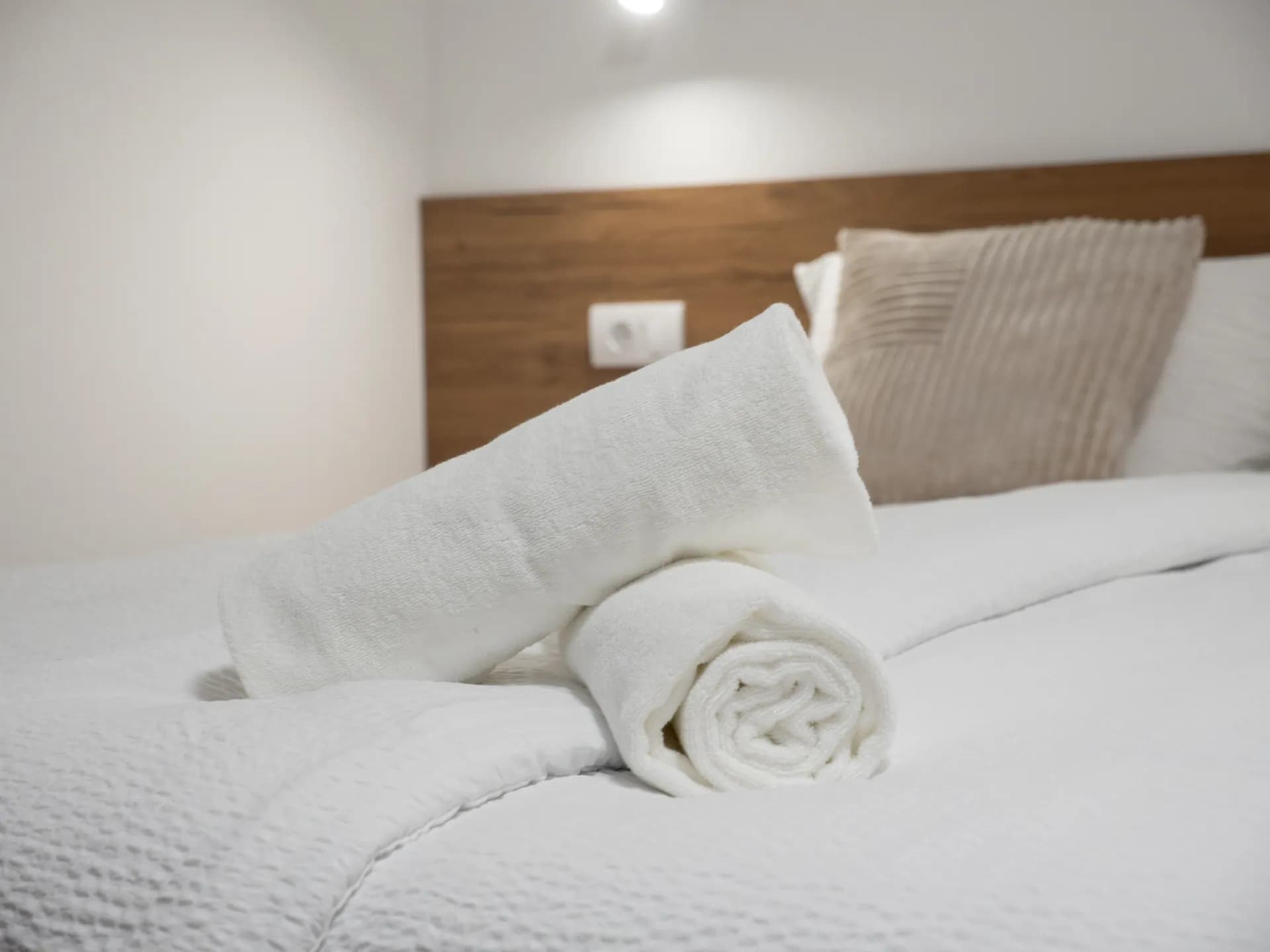 Apartment II — folded towels on the bed